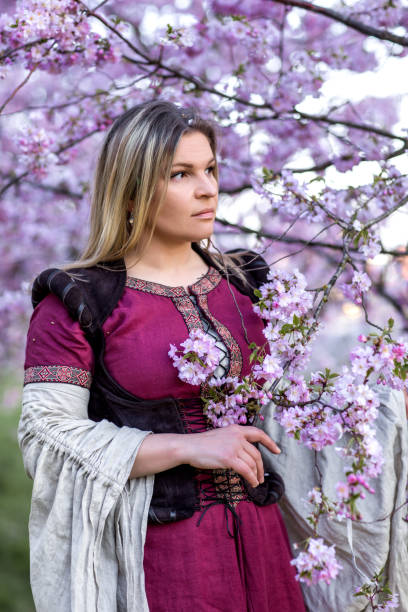 istock Beautiful Russian woman in a cherry tree forest 1312495571