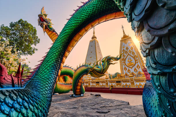 serpente intagliato arcobaleno o colorato naga tailandese che circonda lo stupa sri maha pho chedi al tramonto a wat phra that nong bua - wat maha that foto e immagini stock