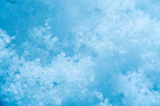 istock Background with close-up of snow under strong magnification. Slightly melted snow with sharp edges in soft focus. 1312498760