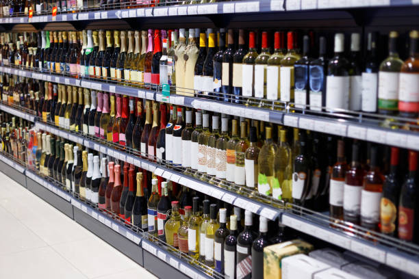 Shelves with variety of alcohol for sale in the supermarket Shelves with variety of alcohol for sale in the supermarket. Vodka, wine, champagne and other alcohol. alcohol shop stock pictures, royalty-free photos & images