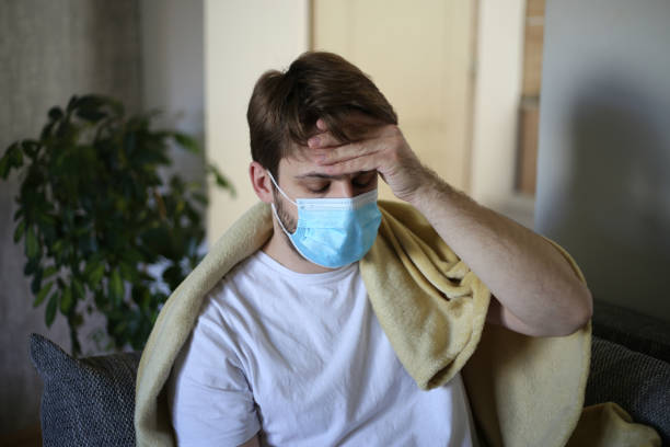 istock Ill man covered with blanket. stock photo 1312501039