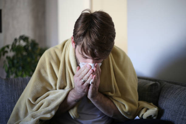istock Ill man covered with blanket. stock photo 1312502319