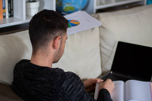 istock young businessman man taking notes at home 1312502718