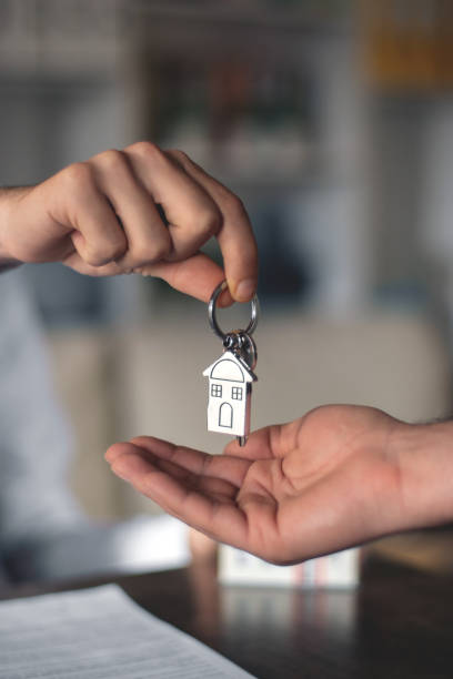 gives the key to the house after sale stock photo