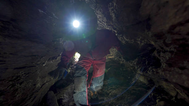 istock Cave explorer with headlamp discovers rare organisms 1312504932