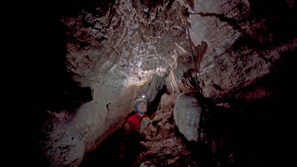 istock Cave explorer with headlamp discovers rare organisms 1312504999