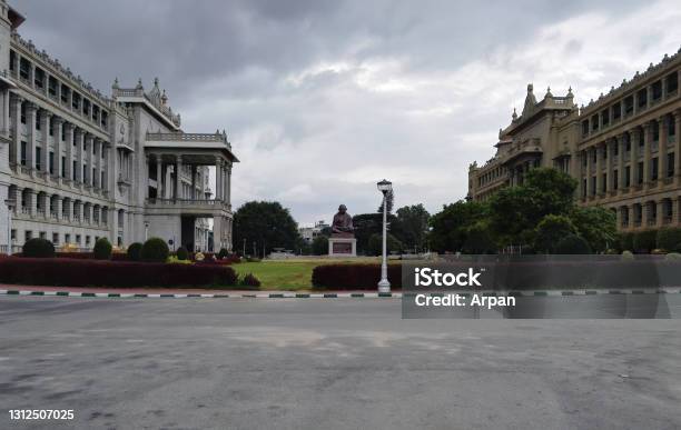 Wide Angle View Of Statue Of Mahatma Gandhi Against Road A Freedom Fighter Known For Peace And The Side View Of Vikasa Soudha Building Famous Landmark In South Stock Photo - Download Image Now