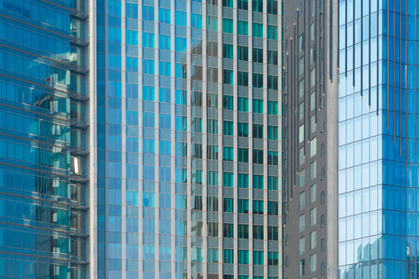 istock Pattern of office buildings windows. Glass architecture facade design with reflection in urban city, Downtown Dubai. Urban city in financial district with blue sky. 1312507380