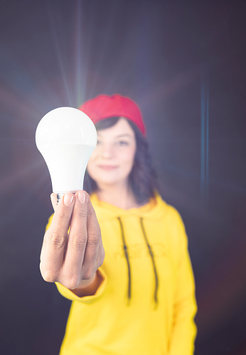 New idea concept. Business inspiration. Find solution concept. woman holding a burning lamp in one hand with his other hand.