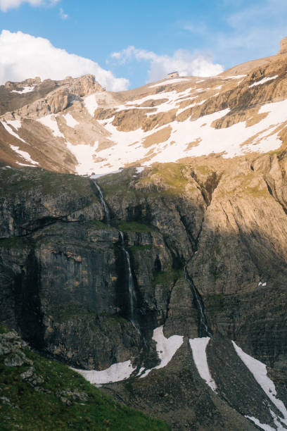istock Rugged mountain peaks with snow and clouds 1312508952