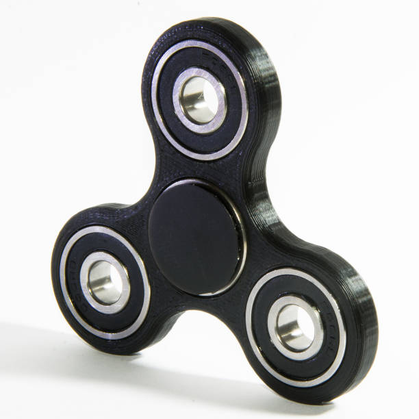 istock Fidget spinner to relax, relieve stress, play 1312509872
