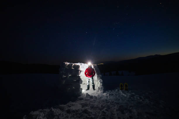 istock Tourist camping in igloo at night while in winter mountain. Alone in nature while COVID-19 pandemic. Mental health and life balance. 1312510364