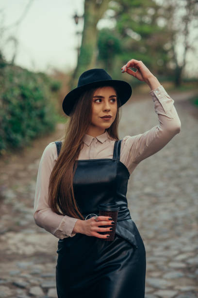 istock Woman drinking coffee takeaway while outside 1312513165