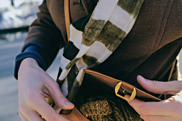 istock beautiful female hands open leather light brown handbag. selective focus photo 1312514513