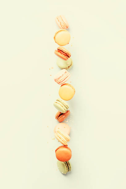 istock Vintage pastel colored French macaroons or macarons in motion falling on light blue background 1312515800