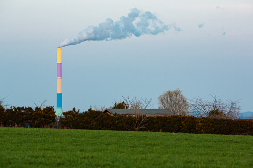 Smoking coal stack from energy plant, still in use in European countries.