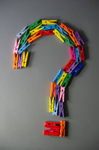 istock question mark is lined with wooden multicolored clothespins on a gray background. 1312517417