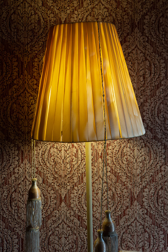 Old lamp with incandescent bulbs on the background of the wall indoors. Cover. Web banner.