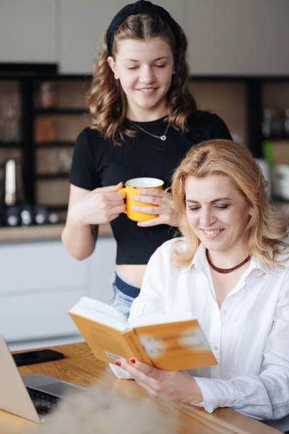 istock Mom and daughter discussing a book 1312518885
