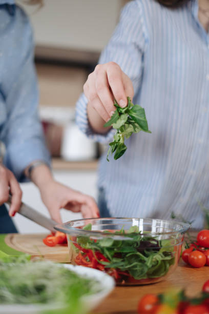 istock Woman hands cooking a salad 1312519271