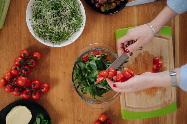 istock Woman hands cooking a salad 1312519278