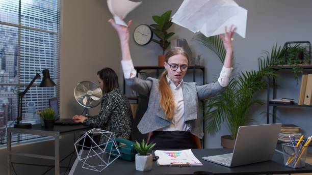 istock Manager irritated sad angry mad after analyzing financial papers in office throwing office documents 1312524622