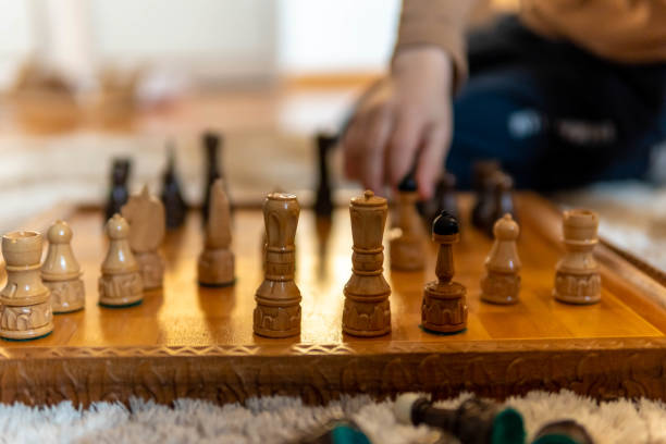 istock A young boy playing chess. He is sitting on the floor playing chess 1312528177