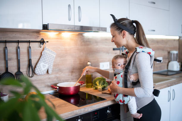 istock Young mother getting assistance in cooking by her baby. 1312528310