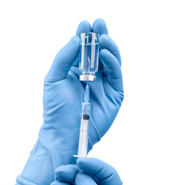 gloved hands hold vaccine and syringe hands in medical gloves hold vaccine and syringe on isolated white background tetanus photos stock pictures, royalty-free photos & images