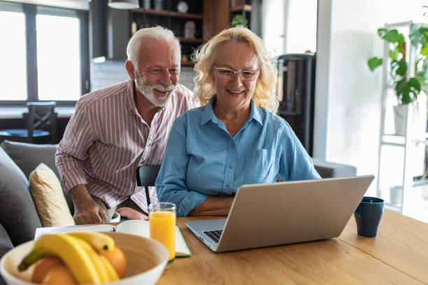 istock Happy senior couple talking on a video call at home 1312528558