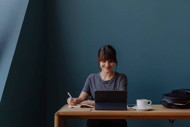 istock Beautiful Woman Having an Online Meeting and Taking Notes (Copy Space) 1312529814