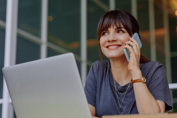 istock Beautiful Woman Smiling while Chatting on the Phone 1312529857