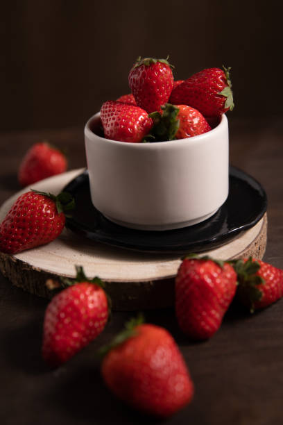 istock Bowl with strawberries on wooden background. 1312530669