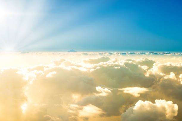 istock Airplane view of clouds, ocean and bright sun 1312531065