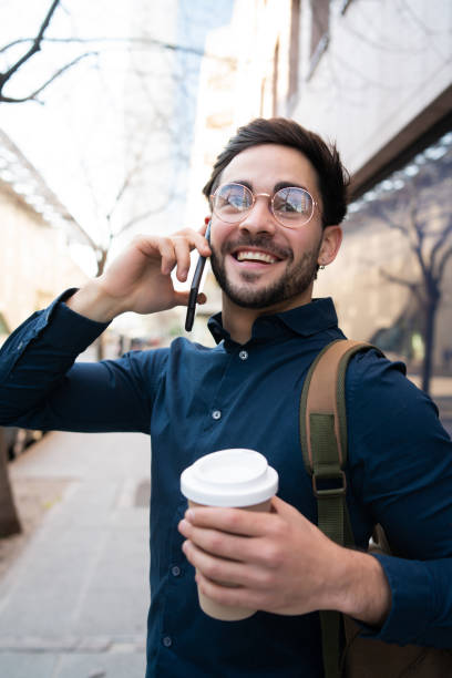 istock Young man talking on the phone outdoors. 1312532046