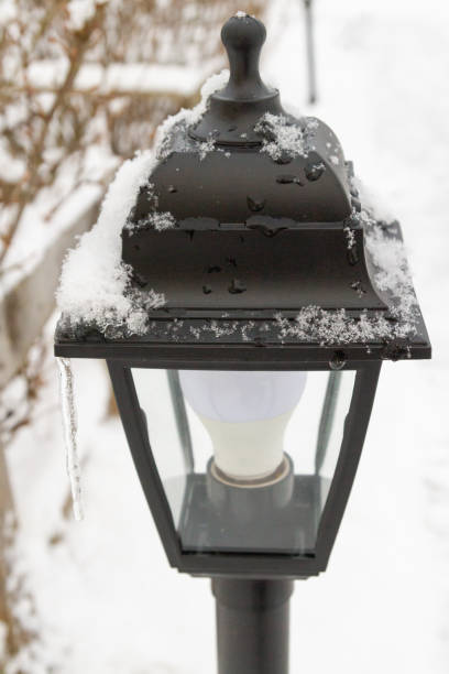 istock Outdoor black lantern in the yard in winter 1312533007
