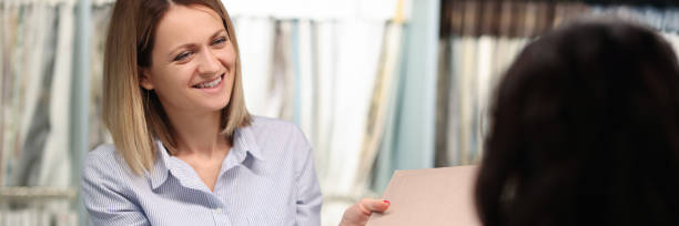 istock Seller shows client the fabric samples in catalog 1312533298
