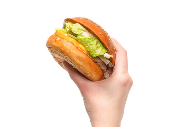 istock Hamburger in woman hands isolated on a white background. 1312535140