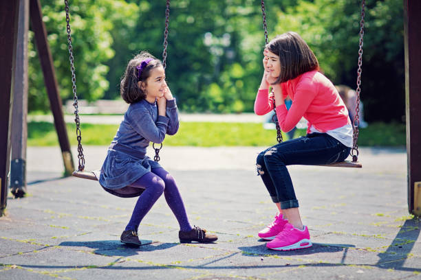  Two little girls are having fun playing together at the playground!