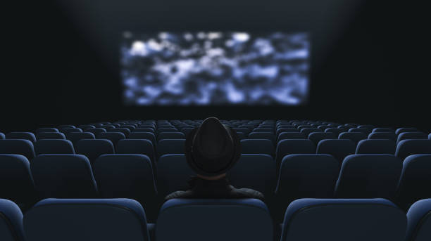 istock Lonely spectator at the cinema. Back view 1312536177