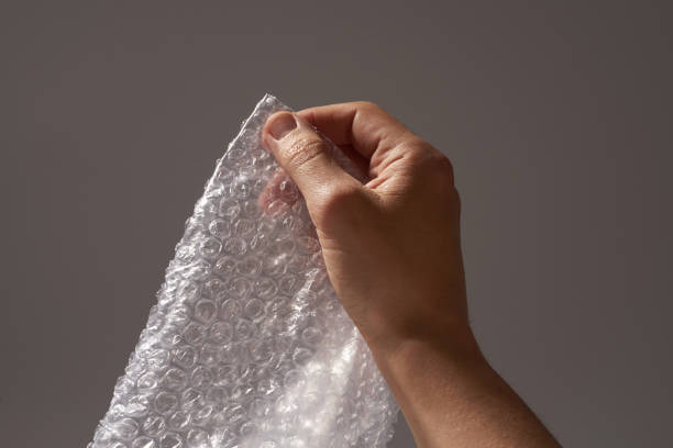 istock Male hand popping bubbles of bubble pack 1312536278