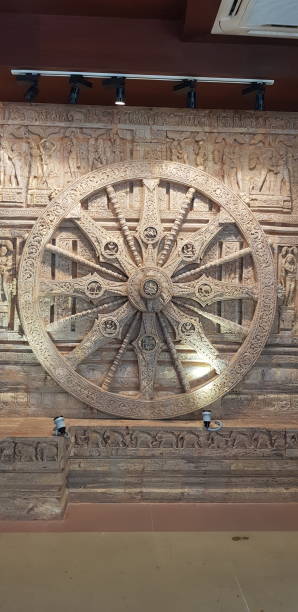 konark sun temple wheel... The Konark or Konarak Sun temple is dedicated to the Hindu sun god Surya, and, conceived as a giant stone chariot with 12 wheels,The 12 stone-carved wheels of the Konark Sun Temple represent the 12 months of a year. These wheels that are found at the base of the temple, also show time. The spokes of the wheel form the shape of a sundial. The exact time of the day can be calculated seeing the shadow cast by the wheels. chariot wheel at konark sun temple india stock pictures, royalty-free photos & images