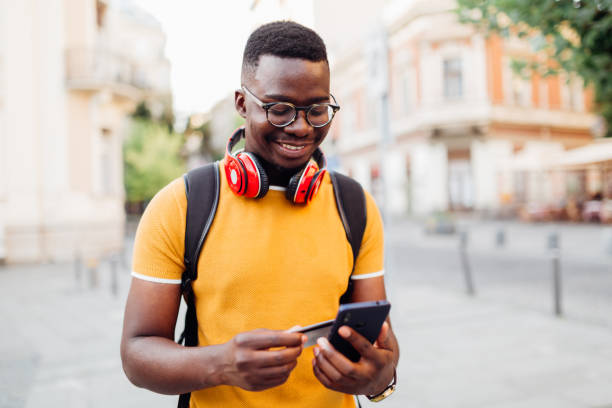 istock Handsome African American man using a credit and a smart phone 1312540246