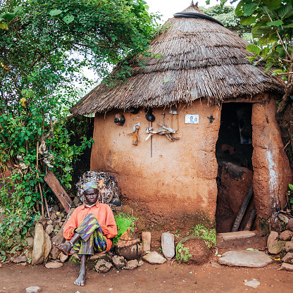 Tata Somba, Benin: Old man sitting infront of his house in small village in Northern Benin's Tata Somba area.