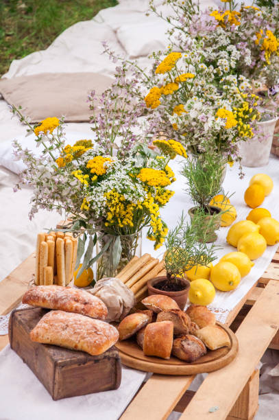 istock Bread of ciabatta, lemons, flowers on a picnic 1312541299