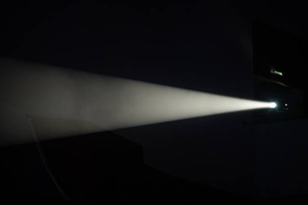 istock Multi-color light on dark stage in fog 1312542264