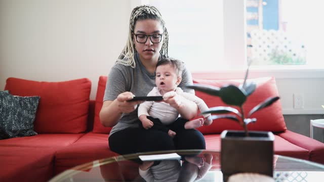 Woman Doing Remote Deposit Capture With Infant Son