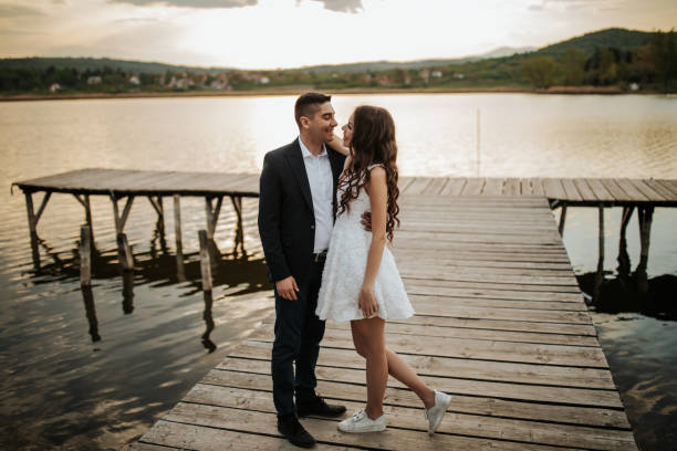 istock Romantic couple on wooden pier 1312548725