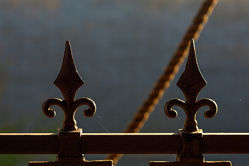 silhouetted decorative ironwork on handrail in typical fleur de lis style