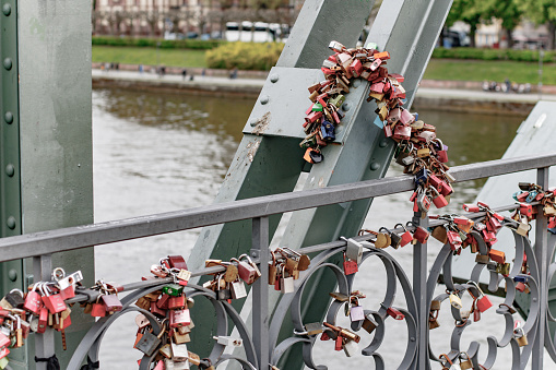 Riverbank with a bridge full of Love locks in Frankfurt